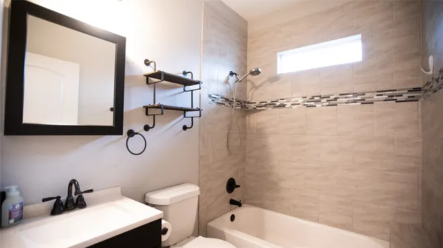 a bathroom with a sink a toilet and a bathtub