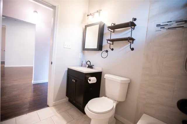 a white toilet sitting next to a bathroom sink