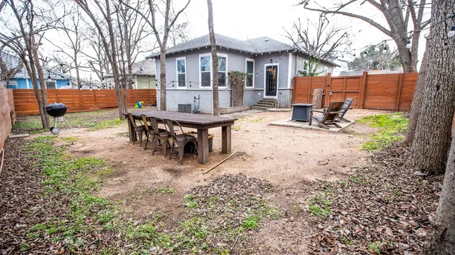 a view of a house with backyard and a sitting area