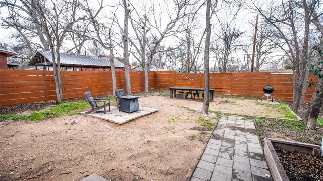 a view of a street with a bench and trees