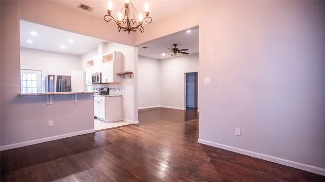 a view of a kitchen with wooden floor and a kitchen