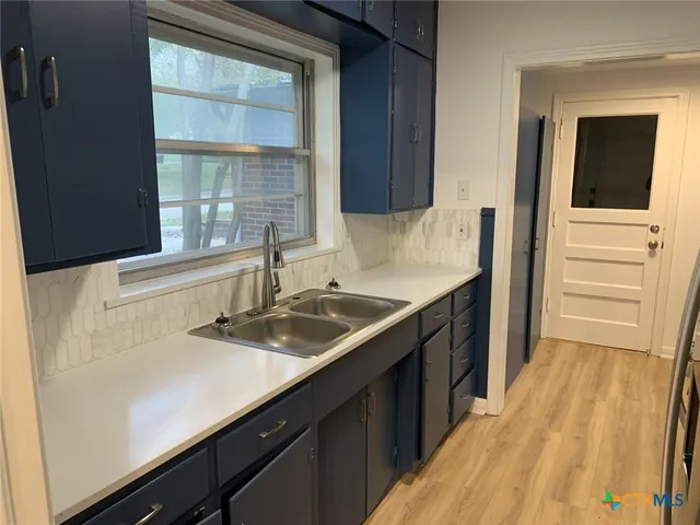 a kitchen with a sink and a window