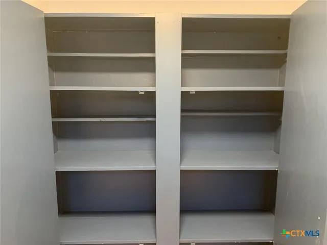 a kitchen with granite countertop a stove and a refrigerator