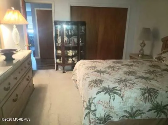 a spacious bedroom with a bed and a lamp