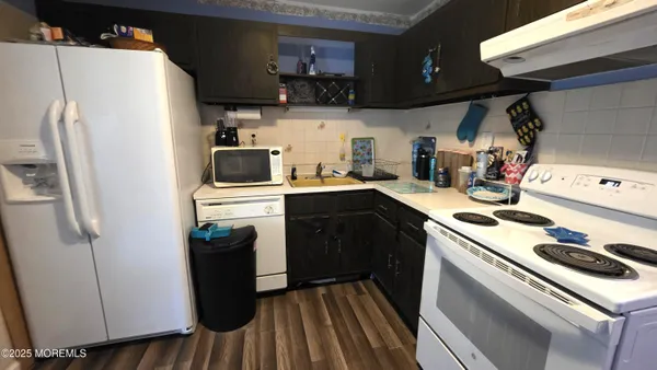 a kitchen with stainless steel appliances a stove a refrigerator and a cabinets