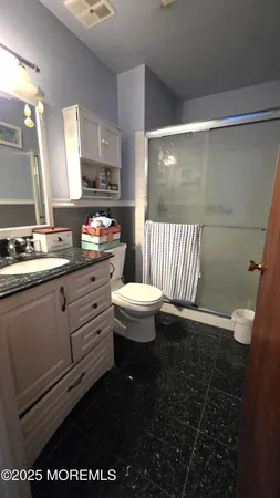 a bathroom with a sink a toilet and mirror