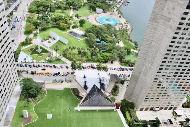 an aerial view of a house with a yard and potted plants