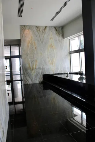 a view of a house with porch and potted plants