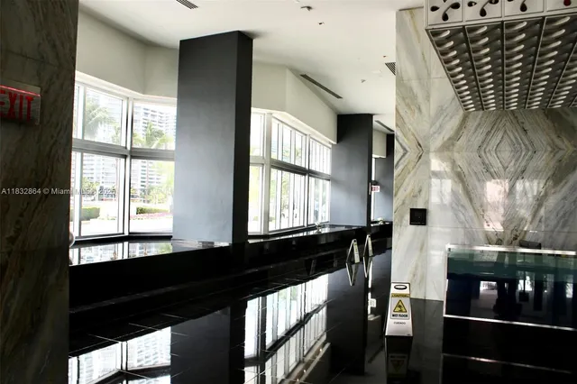 a white vase with flowers on table and window