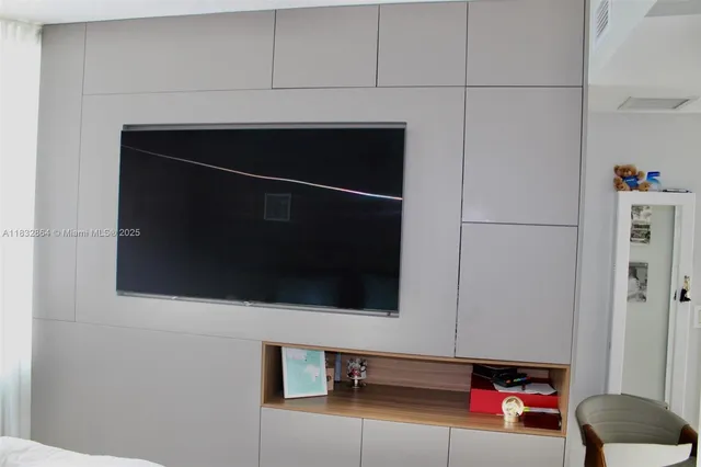 a living room with a flat screen tv and a white door