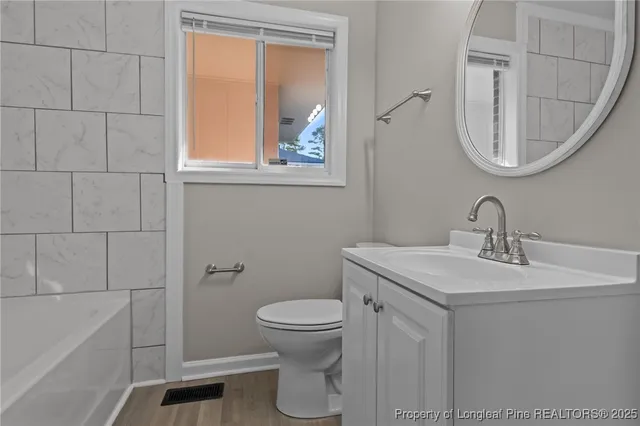 a bathroom with a toilet a sink and a mirror