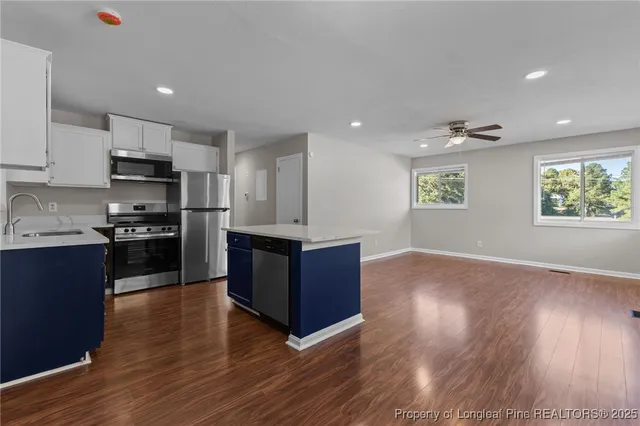 a kitchen with stainless steel appliances granite countertop a stove a sink and a refrigerator