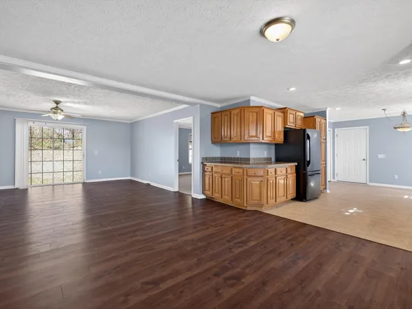 a view of a kitchen with furniture and wooden floor