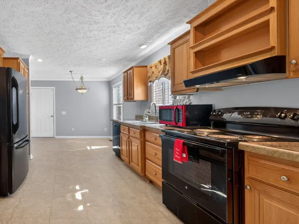 a kitchen with stainless steel appliances granite countertop a stove and a refrigerator