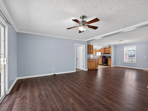 a view of empty room with wooden floor and window