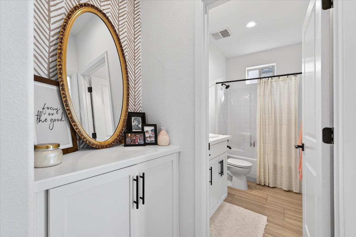 4593 Orchard Hills Road Madera, CA 93636 - Photo 5 of 25 a bathroom with a toilet a sink and a mirror