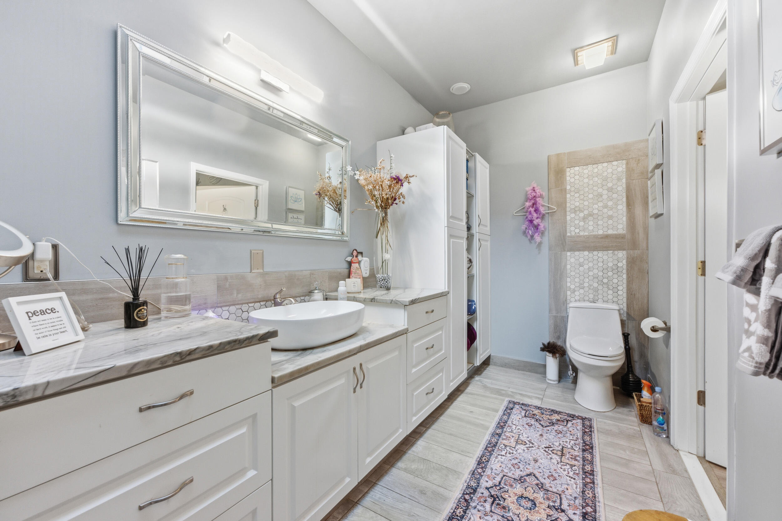 2495 Northwest 66th Drive Boca Raton, FL 33496 - Photo 24 of 74 a spacious bathroom with a granite countertop sink and a mirror