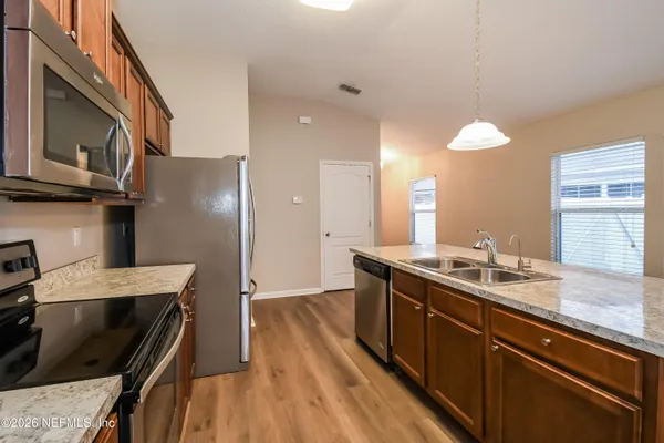 a kitchen with a sink stove and refrigerator