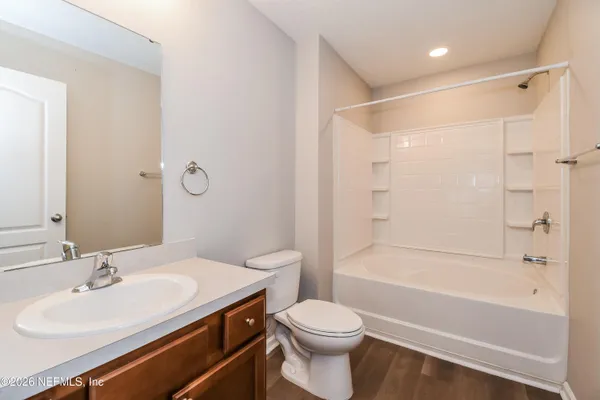 a bathroom with a sink toilet vanity and shower