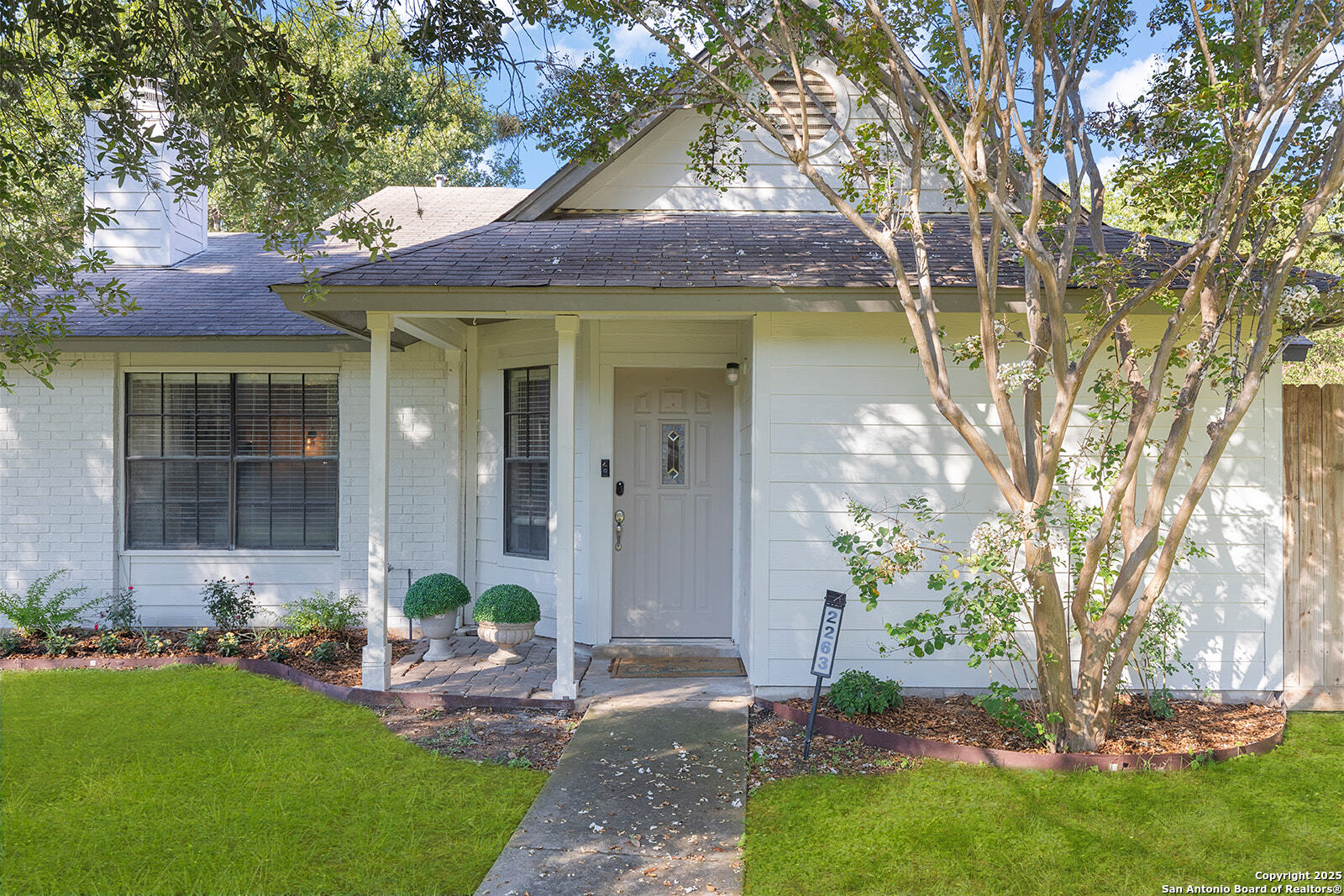 a front view of a house with garden