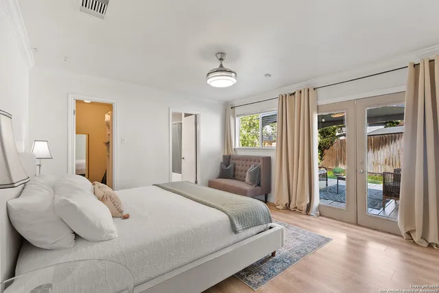 a bedroom with a large bed and a window