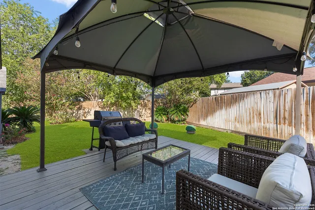 a backyard of a house with table and chairs