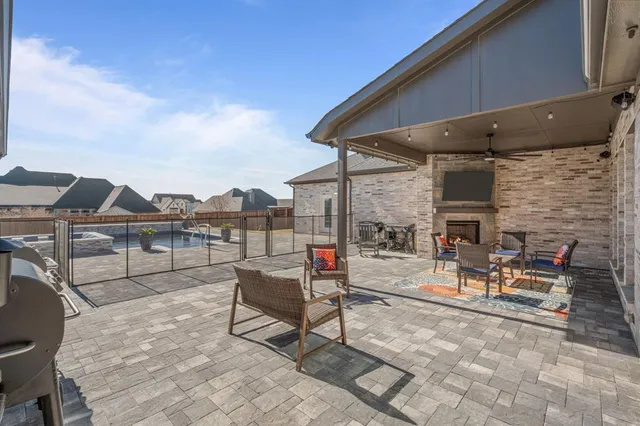a view of a patio with a table and chairs