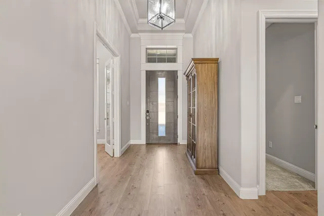a view of a hallway with wooden floor and closet