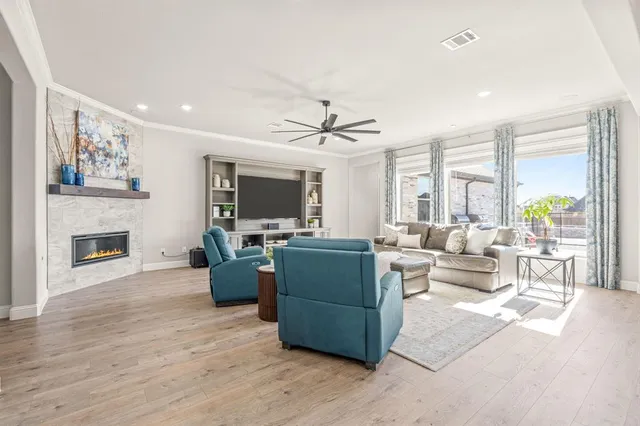 a living room with furniture a fireplace and a flat screen tv