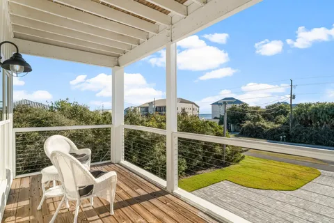 a view of a chairs and table in patio with wooden fence