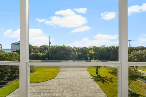 a view of a balcony with furniture and floor to ceiling window