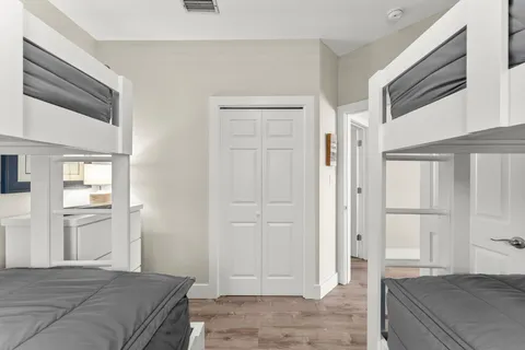 a bedroom with a bed and a refrigerator