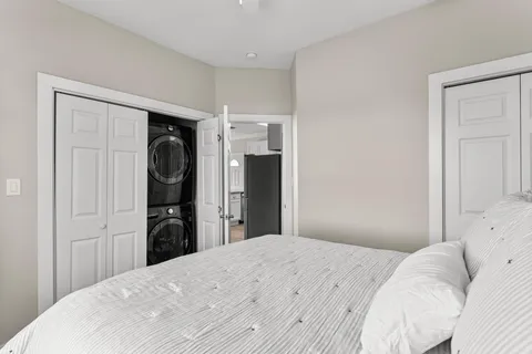 a bedroom with a large bed and a window