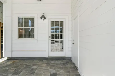 a view of a dinning table and chairs in the patio