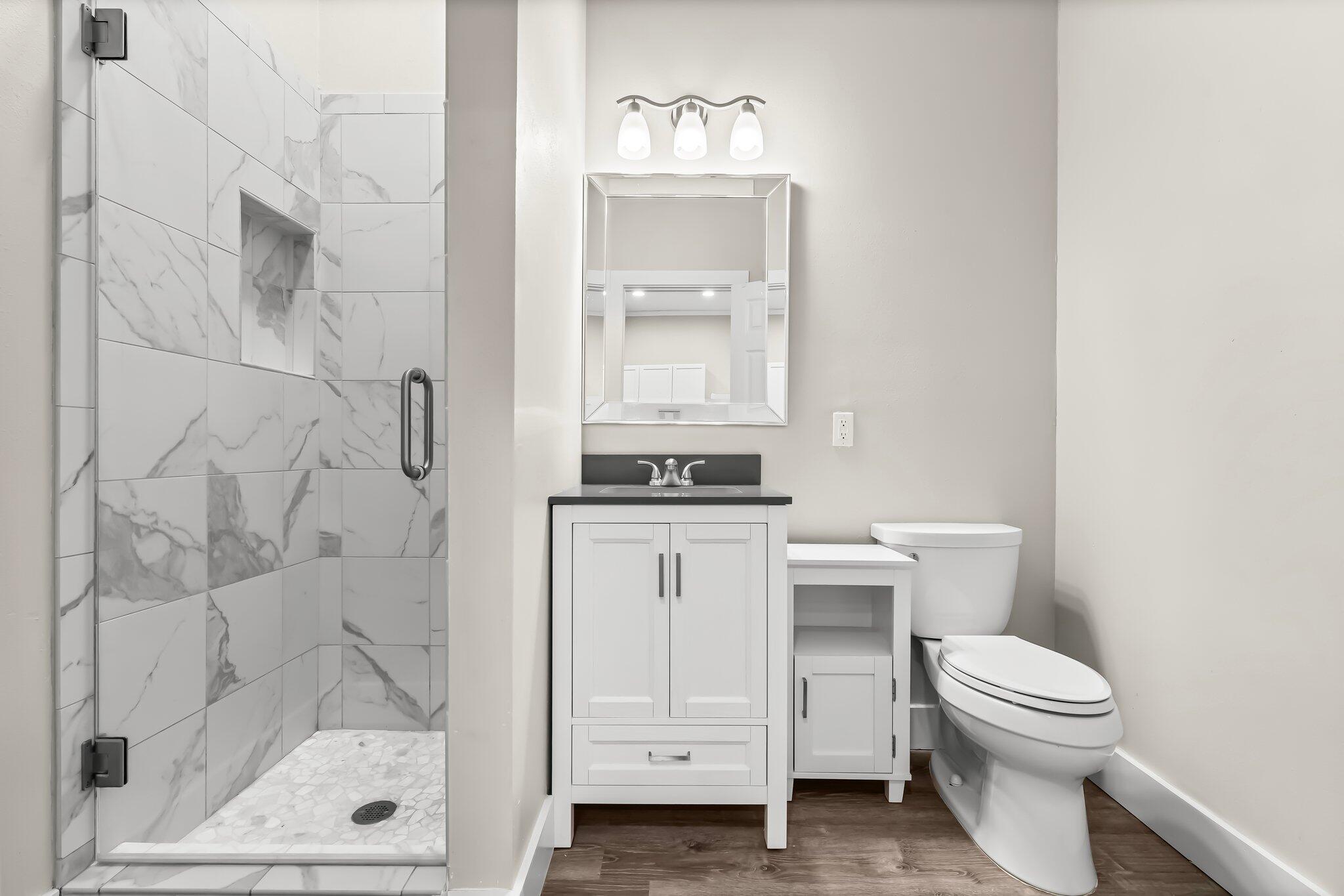 6126 West County Highway 30A Santa Rosa Beach, FL 32459 - Photo 41 of 76 a bathroom with a sink a toilet and shower