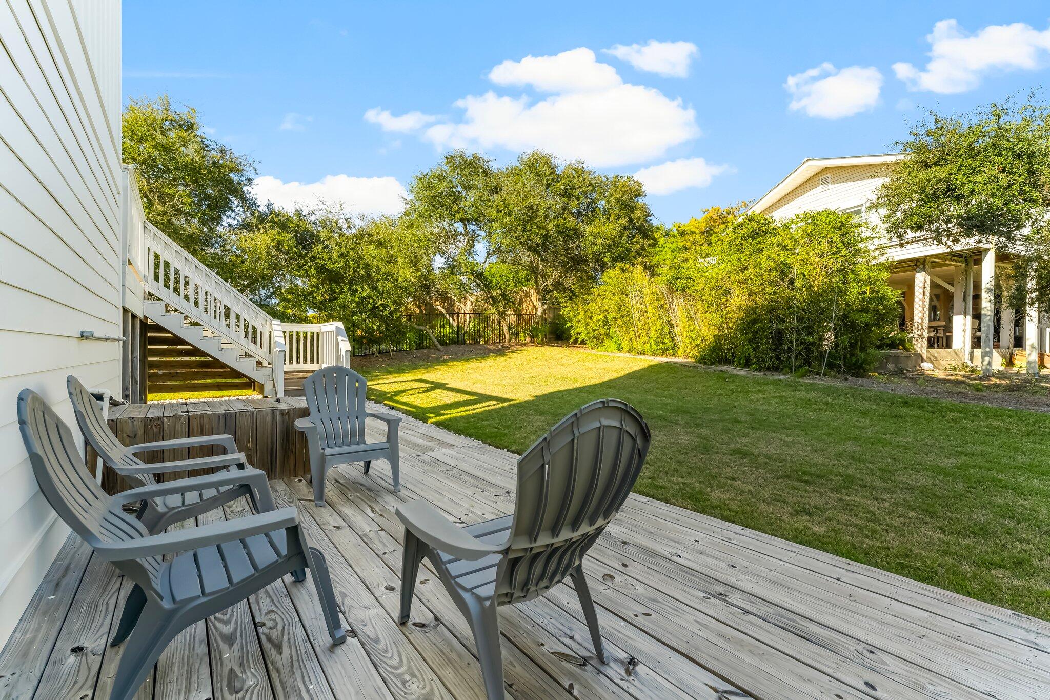 6126 West County Highway 30A Santa Rosa Beach, FL 32459 - Photo 48 of 76 a view of a patio with table and chairs with wooden floor and fence