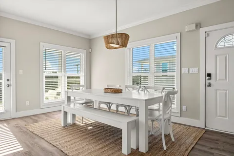 a living room with dining table and a window