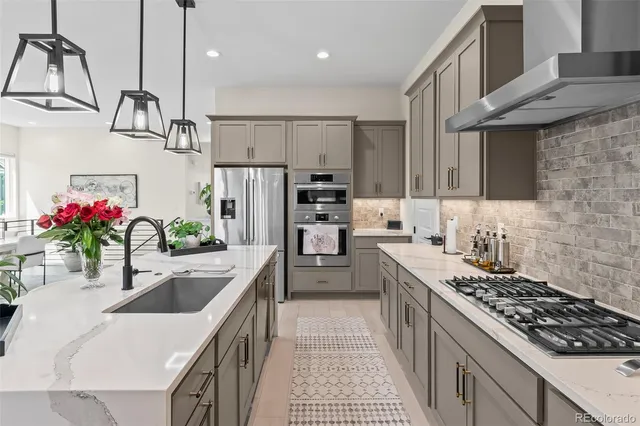 a kitchen with kitchen island granite countertop a sink stainless steel appliances and cabinets
