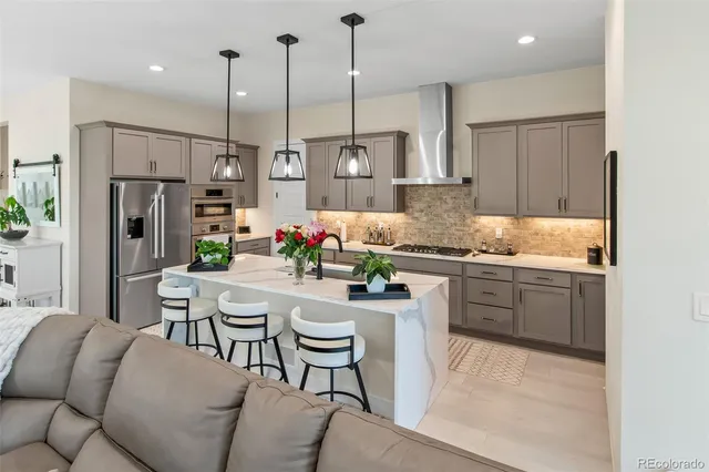 a kitchen with stainless steel appliances granite countertop sink refrigerator and microwave