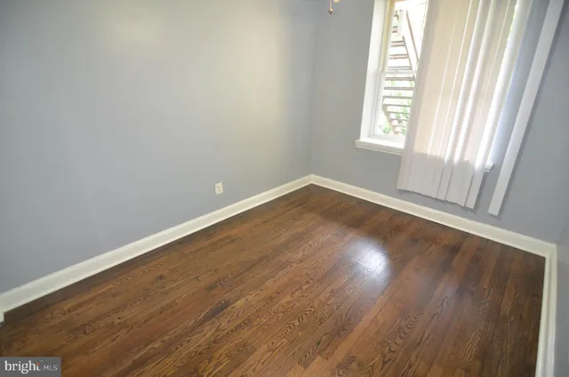 an empty room with wooden floor