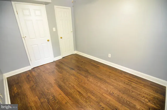 a view of wooden floor and windows in a room