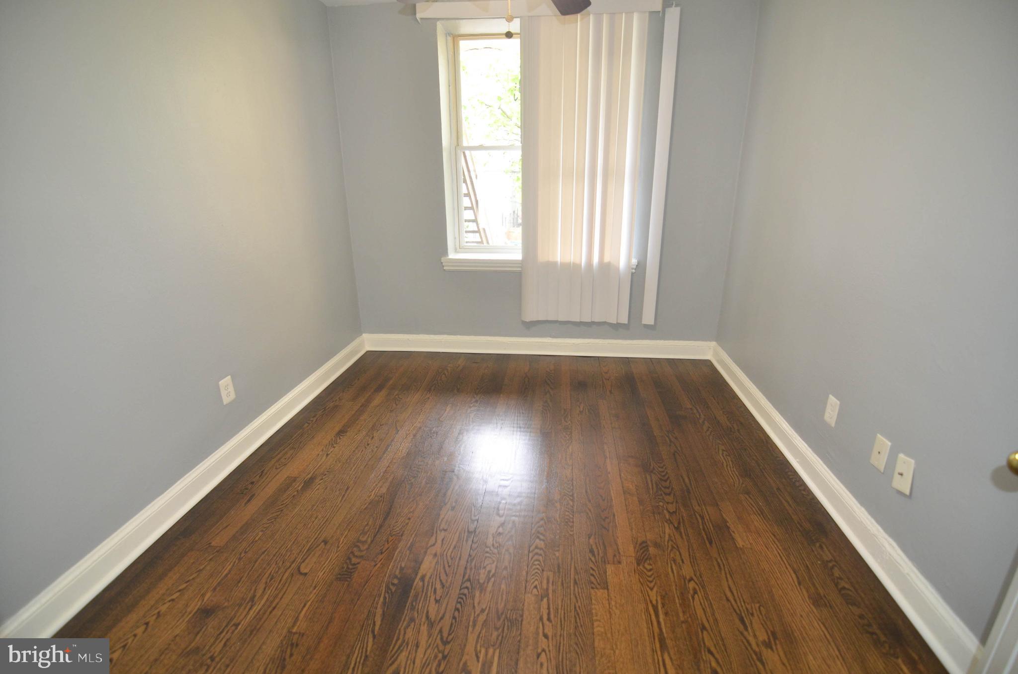 39 Galveston Place Southwest Washington, DC 20032 - Photo 16 of 21 an empty room with wooden floor and windows