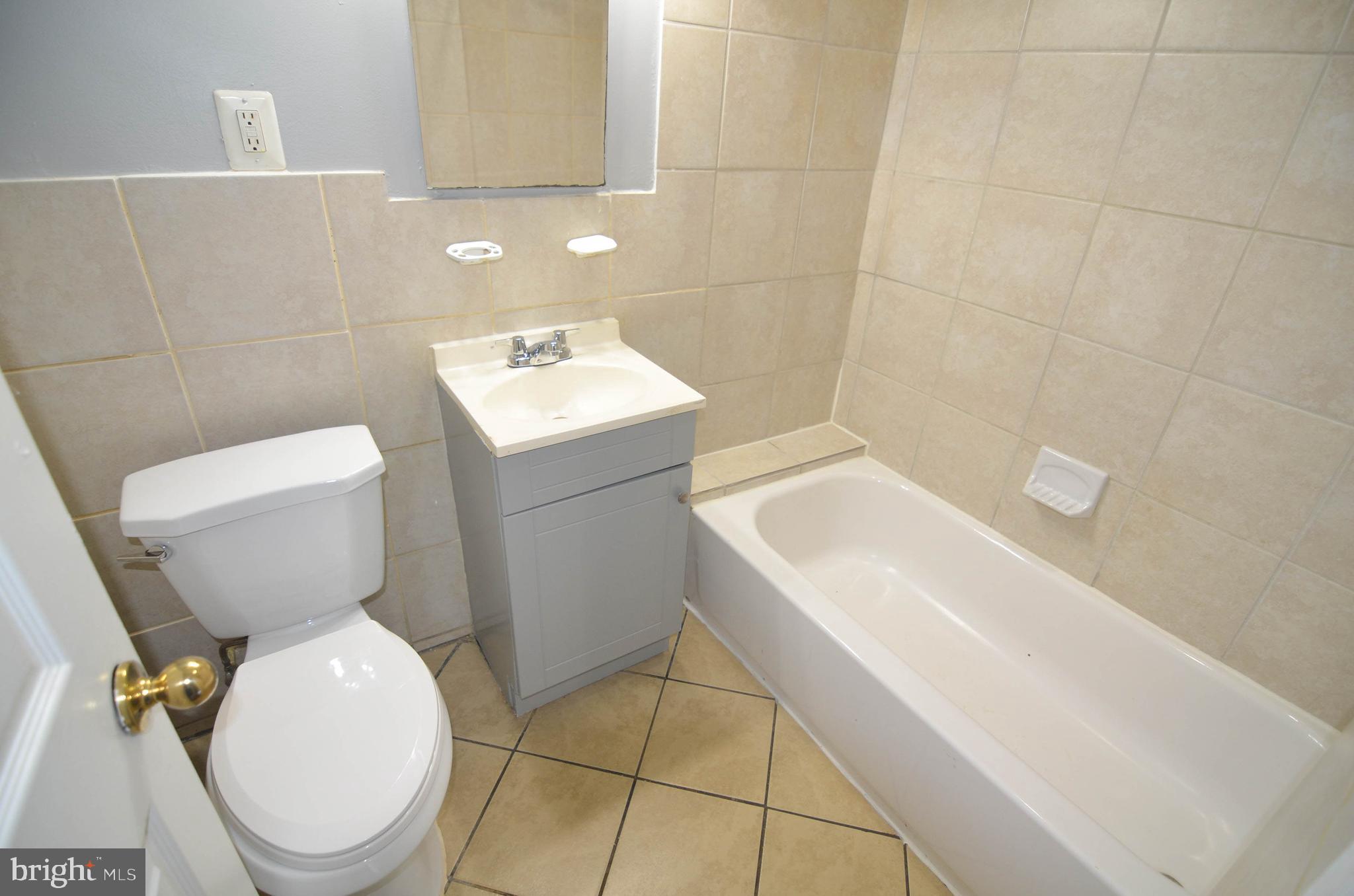 39 Galveston Place Southwest Washington, DC 20032 - Photo 17 of 21 a white toilet sitting next to a bathroom sink