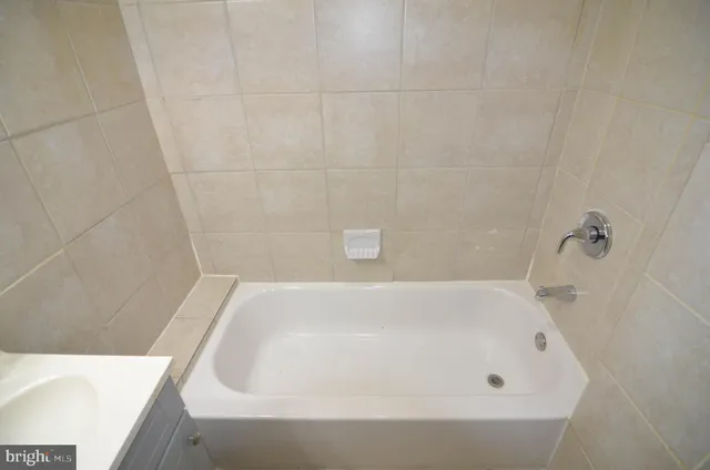 a white toilet sitting next to a bathroom sink