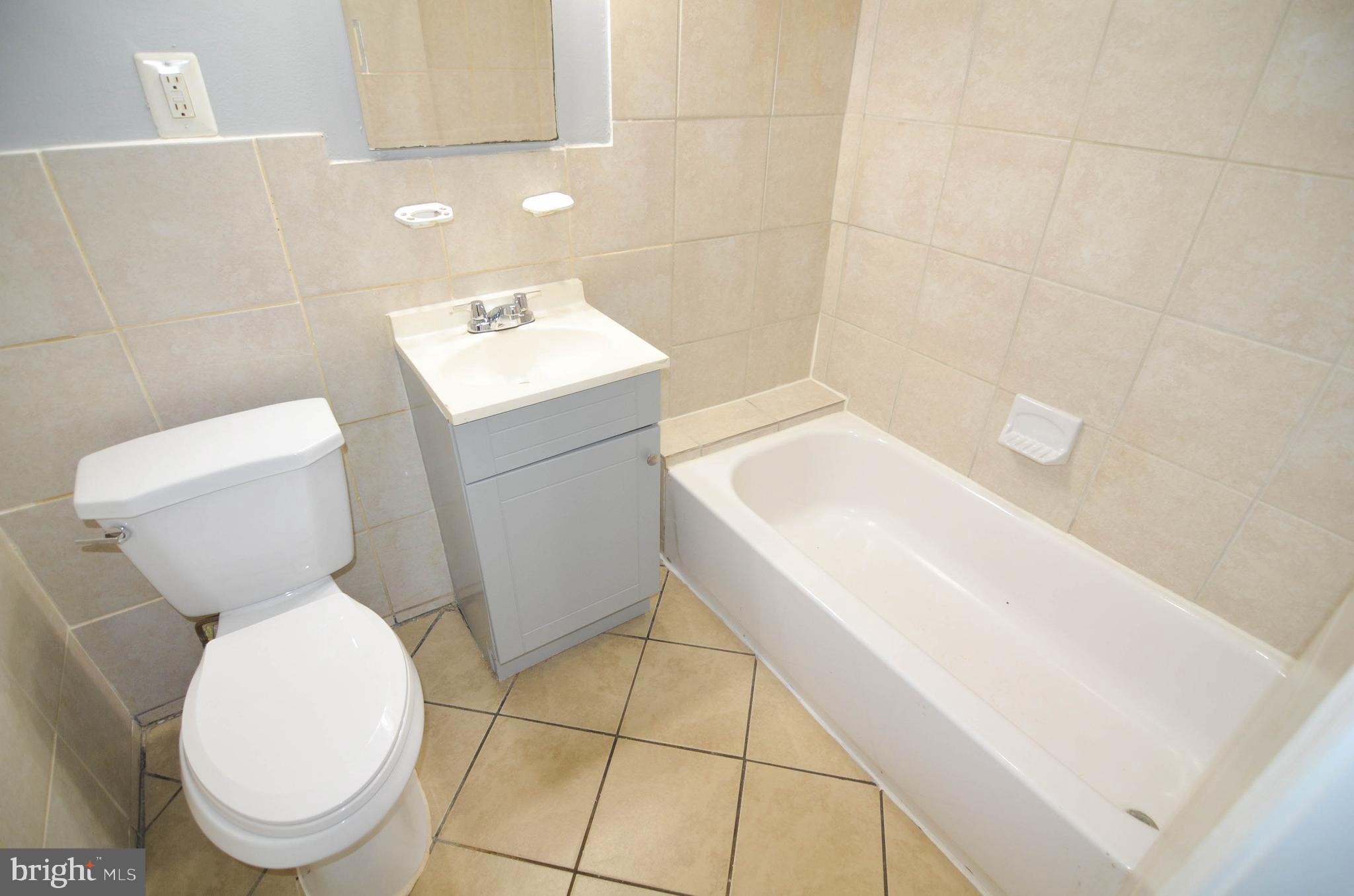 39 Galveston Place Southwest Washington, DC 20032 - Photo 19 of 21 a white toilet sitting next to a bathroom sink