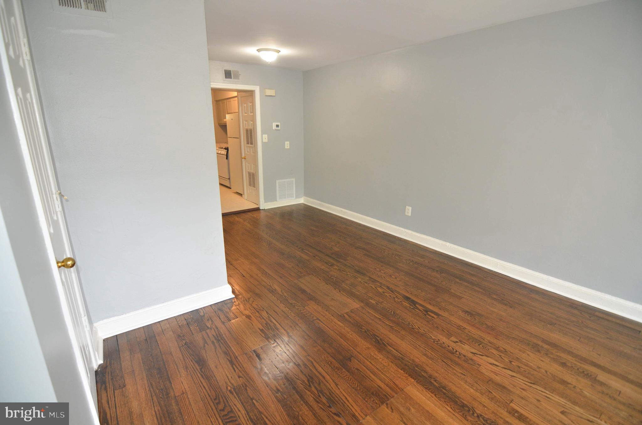 39 Galveston Place Southwest Washington, DC 20032 - Photo 7 of 21 an empty room with wooden floor and sliding door