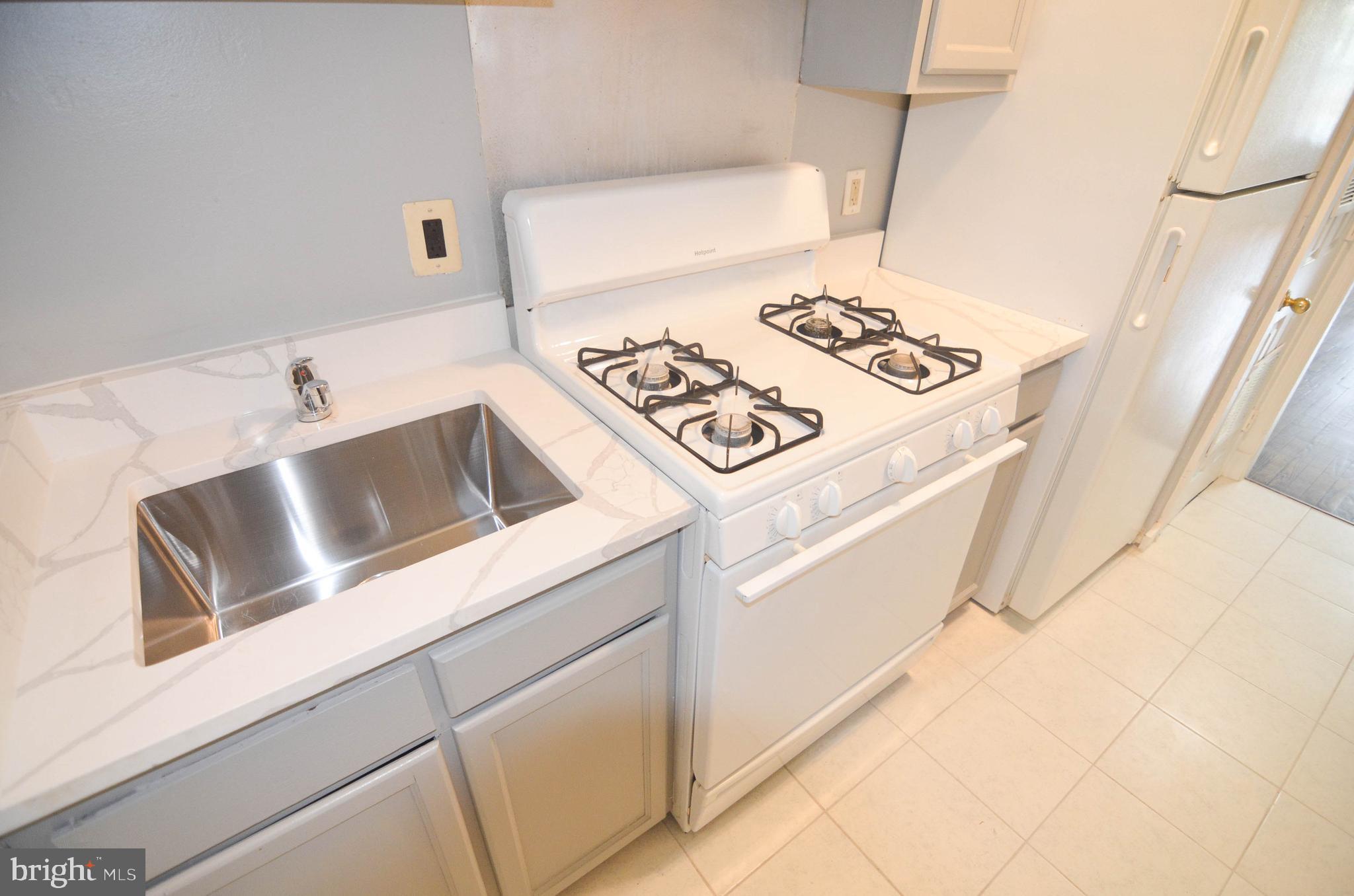 39 Galveston Place Southwest Washington, DC 20032 - Photo 9 of 21 a kitchen with a stove and a refrigerator