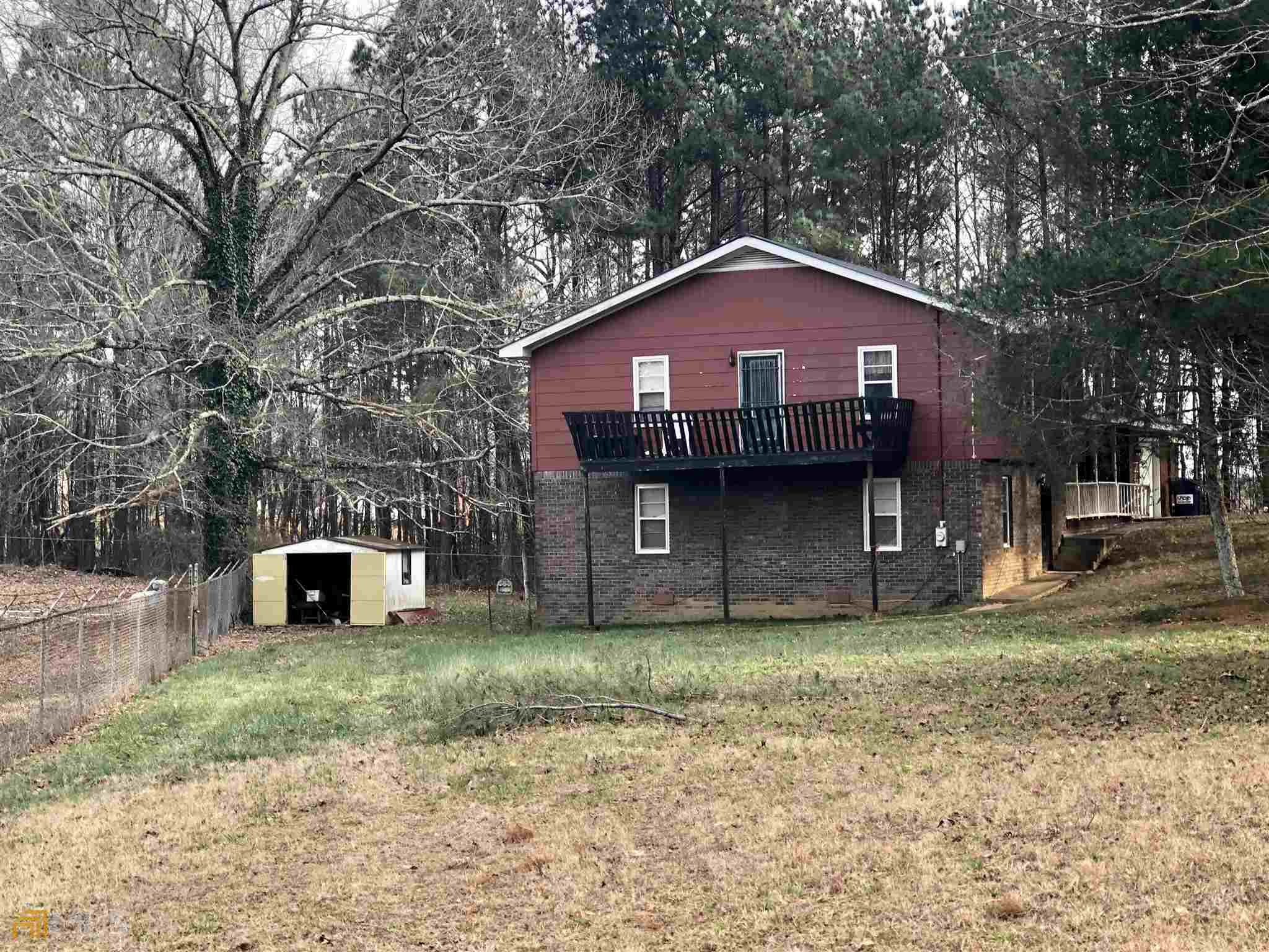 3750 Old Cleveland Road Cornelia, GA 30531 - Photo 4 of 9 a front view of a house with a yard and garage