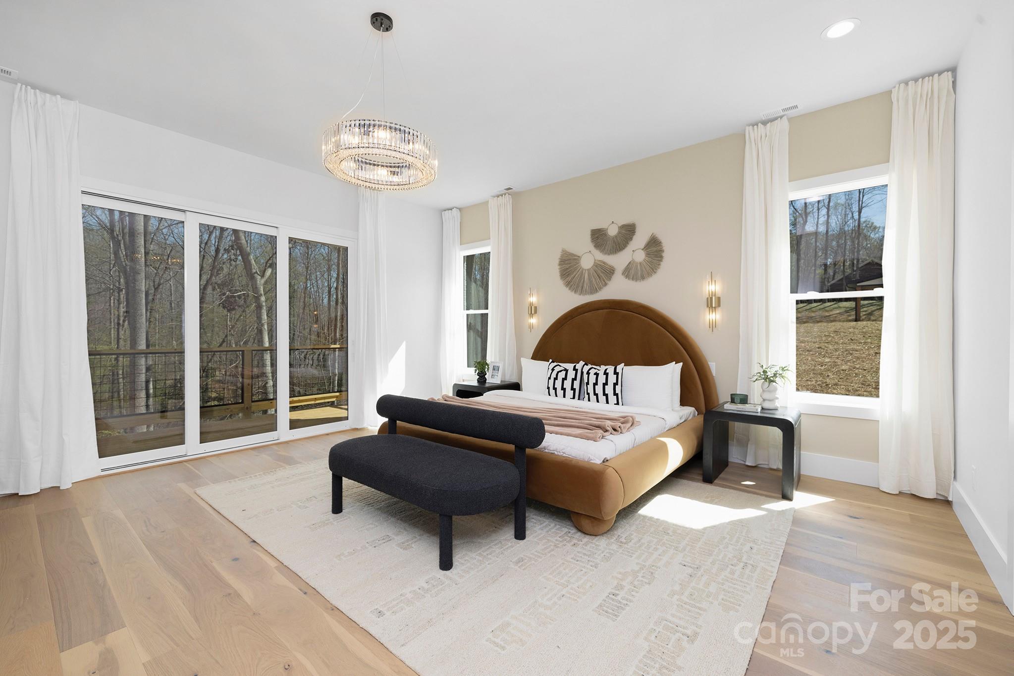 12011 Brief Road Charlotte, NC 28227 - Photo 8 of 12 a spacious bedroom with a bed and a large window