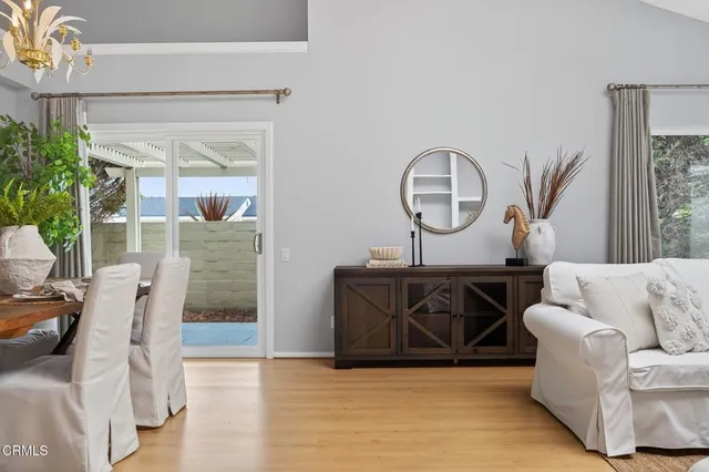 a living room with furniture chandelier and a fireplace